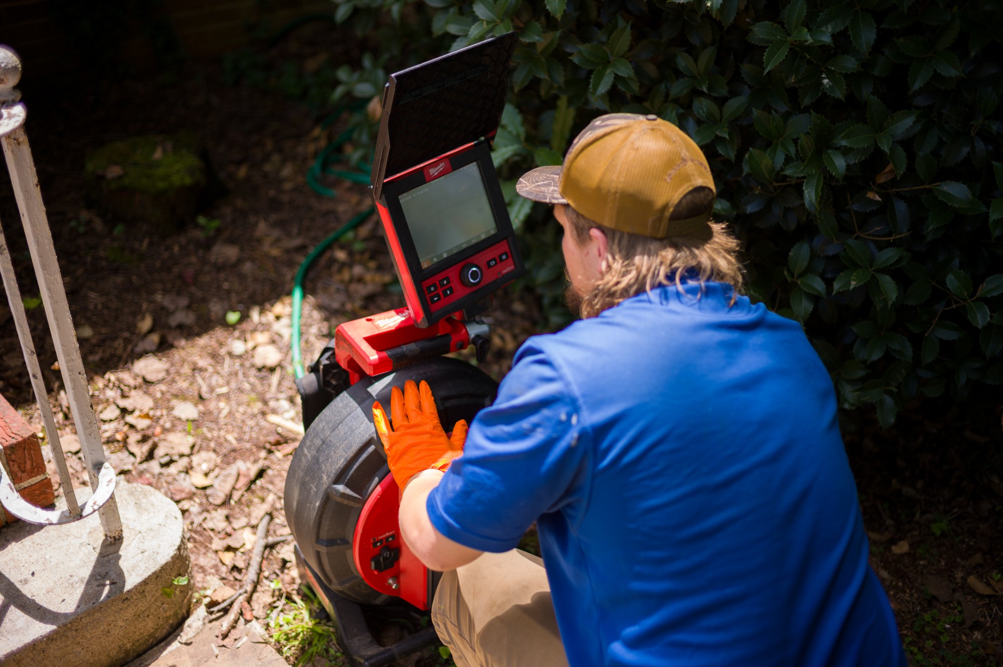 Plumber running a sewer line camera inspection at an older home in Athens, Georgia